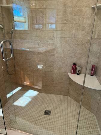 picture of a newly remodeled shower with glass walls and sliding glass doors